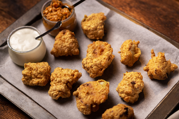 Cauliflower wings food. Pieces of cauliflower cooked in batter. Meat substitute, vegetarian food.